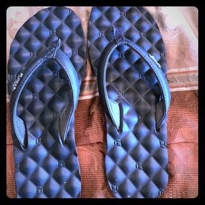 Black reef flip flops.